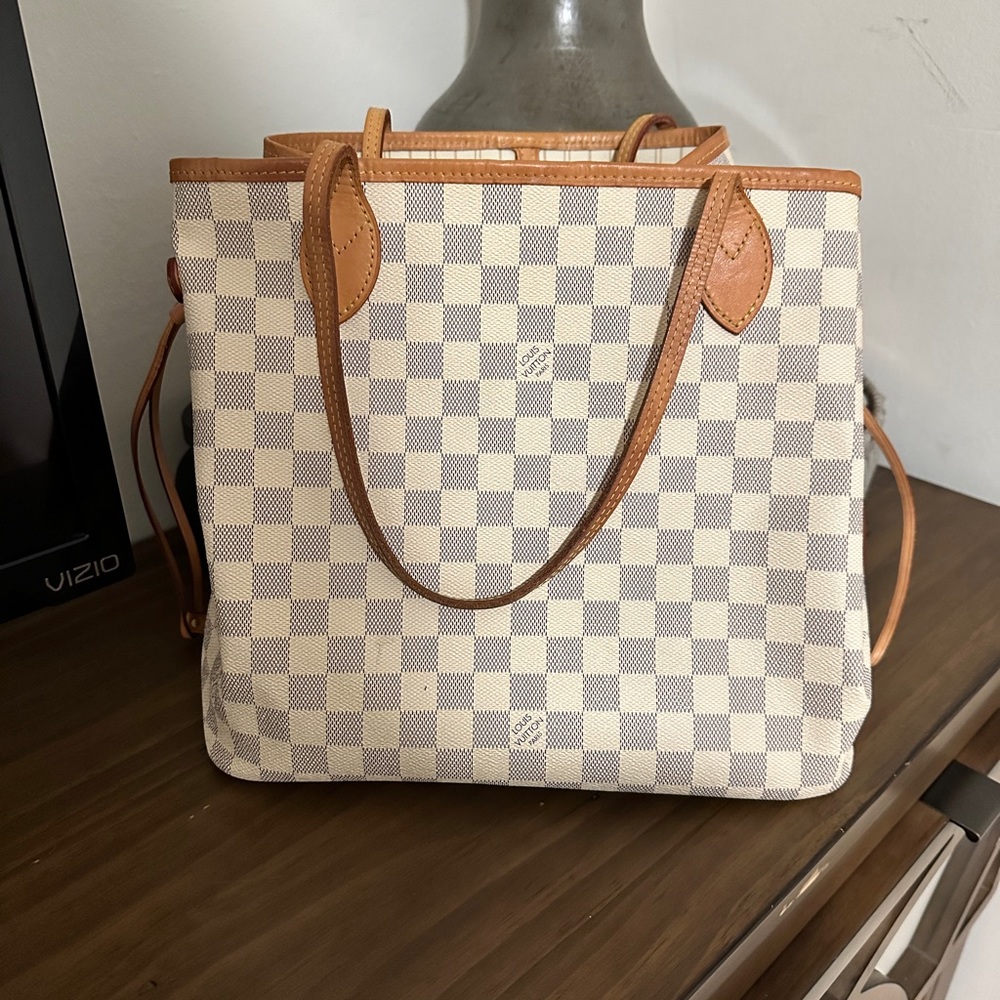 Barely used LV tote, small stain on the interior.